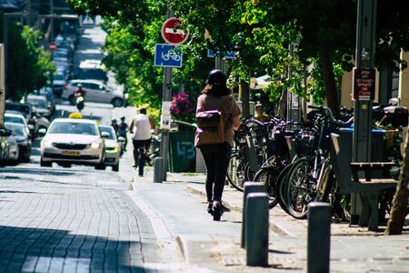 Tel Aviv Israel August 23, 2019 View of unknown Israeli people rolling with a electric scooter in the streets of Tel Aviv in the afternoonの写真素材
