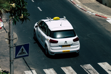Tel Aviv Israel July 16, 2019 View of traditional Israeli taxi rolling in the streets of Tel Aviv in the afternoonのeditorial素材