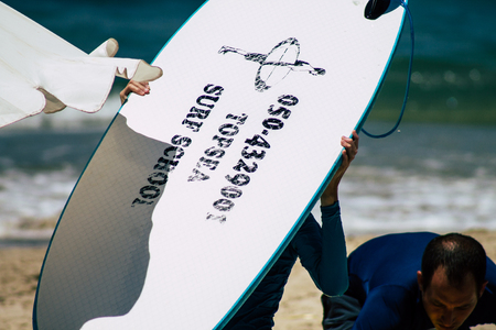 Tel Aviv Israel July 15, 2019 View of unknown Israeli people practicing surfing on Tel Aviv beach in the morningのeditorial素材