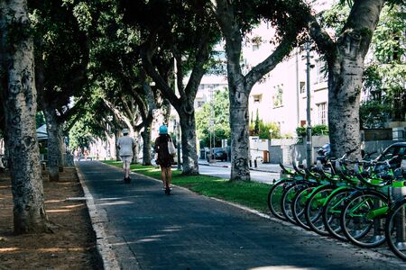 Tel Aviv Israel August 23, 2019 View of unknown Israeli people rolling with a electric scooter in the streets of Tel Aviv in the afternoonの写真素材