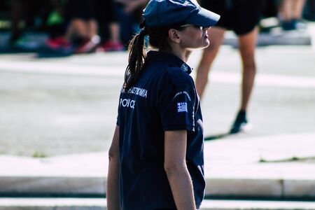 Athens Greece September 1, 2019 View of a cute Greek woman police officer walking front the tomb of the Unknown Soldier in Athens in the morningの写真素材