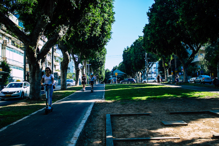 Tel Aviv Israel August 23, 2019 View of unknown Israeli people rolling with a electric scooter in the streets of Tel Aviv in the afternoonのeditorial素材