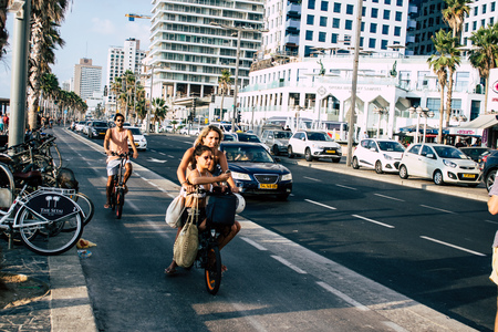 Tel Aviv Israel September 07, 2019 View of unknown people rolling with a bicycle in the streets of Tel Aviv in the afternoonのeditorial素材