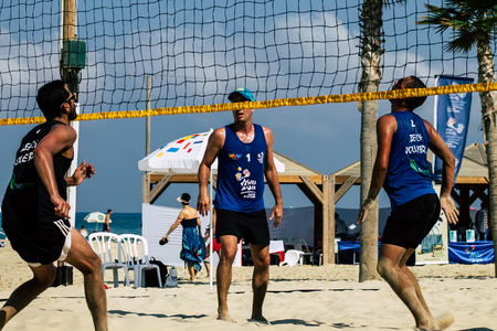 Tel Aviv Israel August 24, 2019 View of unknown Israeli people playing beach volleyball on the public beach of Tel Aviv in the morningのeditorial素材