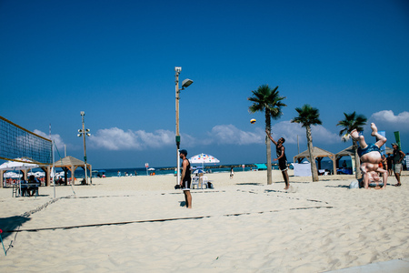 Tel Aviv Israel August 24, 2019 View of unknown Israeli people playing beach volleyball on the public beach of Tel Aviv in the morningのeditorial素材