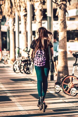 Tel Aviv Israel October 03, 2019 View of unknown Israeli people rolling with a electric scooter in the streets of Tel Aviv in the afternoonの写真素材