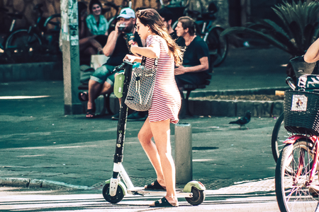 Tel Aviv Israel October 03, 2019 View of unknown Israeli people rolling with a electric scooter in the streets of Tel Aviv in the afternoonのeditorial素材