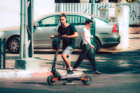 Tel Aviv Israel October 08, 2019 View of unknown Israeli people rolling with an electric scooter in the streets of Tel Aviv in the afternoonのeditorial素材