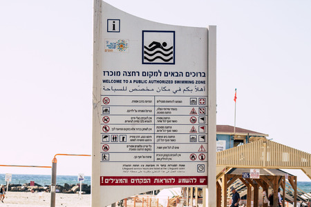 Tel Aviv Israel October 07, 2019 View of an information sign on the Tel Aviv beach in the afternoon about allowed swimming zonesのeditorial素材