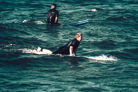 Tel Aviv Israel October 07, 2019 View of unknown Israeli people practicing surfing on Tel Aviv beach in the morningのeditorial素材