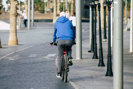 Tel Aviv Israel December 04, 2019 View of unknown people rolling with a bicycle in the streets of Tel Aviv in the afternoonの写真素材