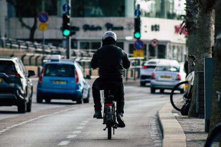 Tel Aviv Israel December 04, 2019 View of unknown people rolling with a bicycle in the streets of Tel Aviv in the afternoonの写真素材