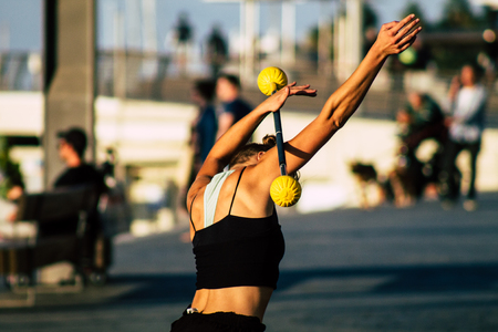 Tel Aviv Israel December 04, 2019 View of a girl dancing with a stick front the beach of Tel Aviv in the afternoonのeditorial素材