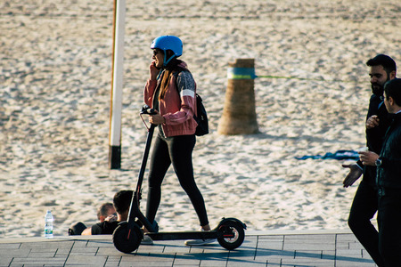 Tel Aviv Israel December 07, 2019 View of unknown Israeli people rolling with a electric scooter in the streets of Tel Aviv in the afternoonのeditorial素材