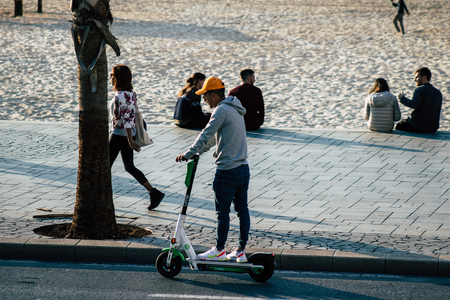 Tel Aviv Israel December 07, 2019 View of unknown Israeli people rolling with a electric scooter in the streets of Tel Aviv in the afternoonのeditorial素材