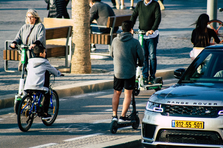 Tel Aviv Israel December 07, 2019 View of unknown Israeli people rolling with a electric scooter in...