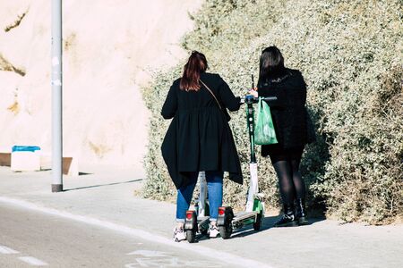 Tel Aviv Israel December 22, 2019 View of unidentified people rolling with a electric scooter in the streets of Tel Aviv in the afternoonの写真素材