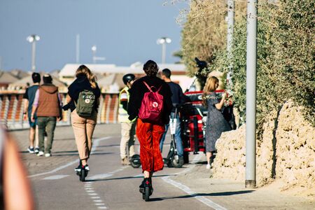Tel Aviv Israel December 22, 2019 View of unidentified people rolling with a electric scooter in the streets of Tel Aviv in the afternoonの写真素材