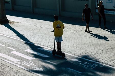 Tel Aviv Israel December 22, 2019 View of unidentified people rolling with a electric scooter in the streets of Tel Aviv in the afternoonの写真素材