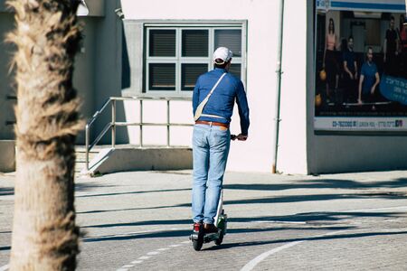 Tel Aviv Israel December 22, 2019 View of unidentified people rolling with a electric scooter in the streets of Tel Aviv in the afternoonの写真素材