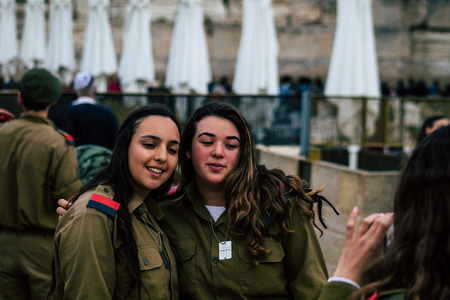 Jerusalem Israel December 11, 2019 View of Israeli soldiers having fun front the Western Wall of the old city of Jerusalem on the eveningのeditorial素材