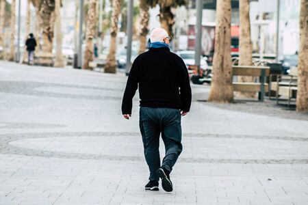 Tel Aviv Israel December 25, 2019 View of unidentified people walking on Herbert Samuel Promenade in Tel Aviv in the afternoonの写真素材