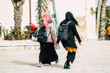 Tel Aviv Israel December 25, 2019 View of unidentified Muslim teen walking in the streets of Jaffa, the southern and oldest part of Tel Aviv in the afternoonの写真素材