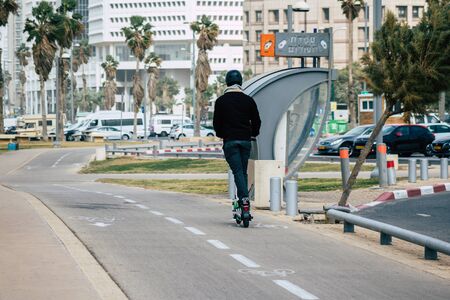 Tel Aviv Israel December 25, 2019 View of unidentified people rolling with a electric scooter in the streets of Tel Aviv in the afternoonの写真素材