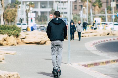 Tel Aviv Israel December 25, 2019 View of unidentified people rolling with a electric scooter in the streets of Tel Aviv in the afternoonの写真素材