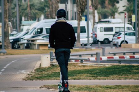 Tel Aviv Israel December 25, 2019 View of unidentified people rolling with a electric scooter in the streets of Tel Aviv in the afternoonの写真素材