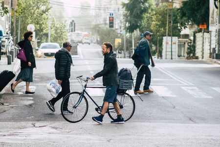 Tel Aviv Israel December 25, 2019 View of unidentified people rolling with a bicycle in the streets of Tel Aviv in the afternoonのeditorial素材