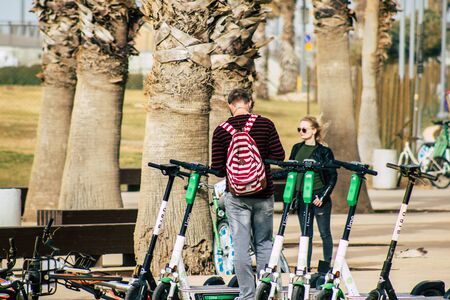 Tel Aviv Israel December 25, 2019 View of unidentified people rolling with a electric scooter in the streets of Tel Aviv in the afternoonのeditorial素材