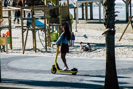 Tel Aviv Israel December 31, 2019 View of unidentified people rolling with an electric scooter in the streets of Tel Aviv in the afternoonの写真素材
