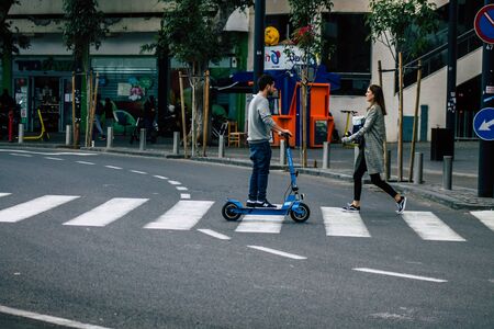 Tel Aviv Israel January 03, 2020 View of unidentified people rolling with an electric scooter in the streets of Tel Aviv in winterの写真素材