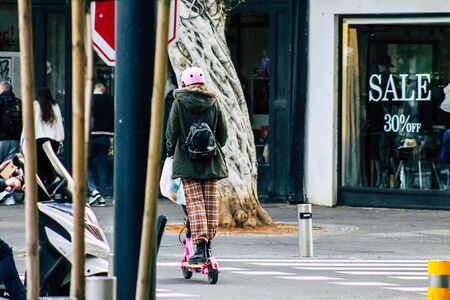Tel Aviv Israel January 03, 2020 View of unidentified people rolling with an electric scooter in the streets of Tel Aviv in winterの写真素材