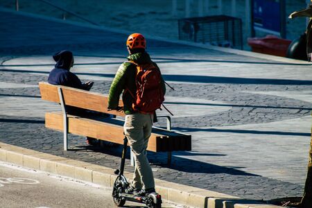 Tel Aviv Israel January 06, 2020 View of unidentified people rolling with an electric scooter in the streets of Tel Aviv in winterの写真素材