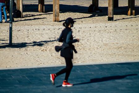 Tel Aviv Israel January 06, 2020 View of unidentified people running on Herbert Samuel Promenade in Tel Aviv in winterの写真素材