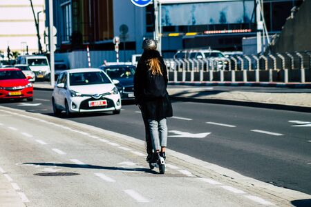 Tel Aviv Israel January 06, 2020 View of unidentified people rolling with an electric scooter in the streets of Tel Aviv in winterの写真素材