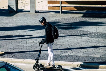 Tel Aviv Israel January 06, 2020 View of unidentified people rolling with an electric scooter in the streets of Tel Aviv in winterの写真素材