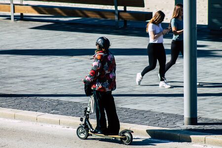 Tel Aviv Israel January 06, 2020 View of unidentified people rolling with an electric scooter in the streets of Tel Aviv in winterの写真素材
