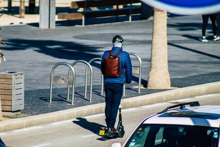 Tel Aviv Israel January 06, 2020 View of unidentified people rolling with an electric scooter in the streets of Tel Aviv in winterの写真素材