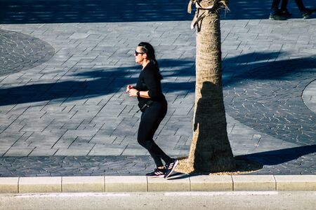 Tel Aviv Israel January 06, 2020 View of unidentified people running on Herbert Samuel Promenade in Tel Aviv in winterの写真素材