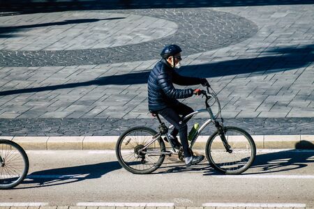 Tel Aviv Israel January 06, 2020 View of unidentified people rolling with a bicycle in the streets of Tel Aviv in winterの写真素材