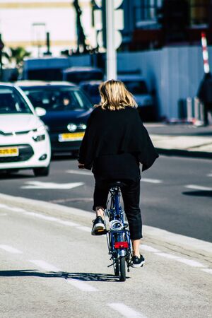 Tel Aviv Israel January 06, 2020 View of unidentified people rolling with a bicycle in the streets of Tel Aviv in winterの写真素材