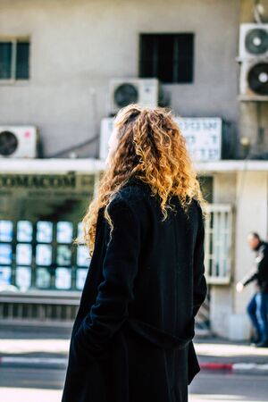 Tel Aviv Israel January 7, 2020 View of unidentified Israeli girl at the bus stop in the streets of Tel Aviv in the afternoonの写真素材