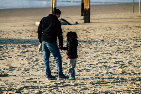 Tel Aviv Israel January 10, 2020 View of unidentified Israeli kid having fun on the beach of Tel Aviv during a sunny day in winterの写真素材