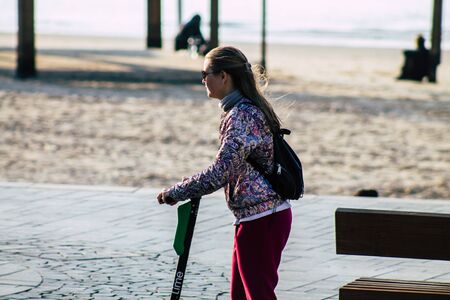 Tel Aviv Israel January 10, 2020 View of unidentified people rolling with an electric scooter in the streets of Tel Aviv in winterの写真素材