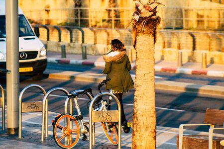 Tel Aviv Israel January 10, 2020 View of unidentified people rolling with an electric scooter in the streets of Tel Aviv in winterの写真素材