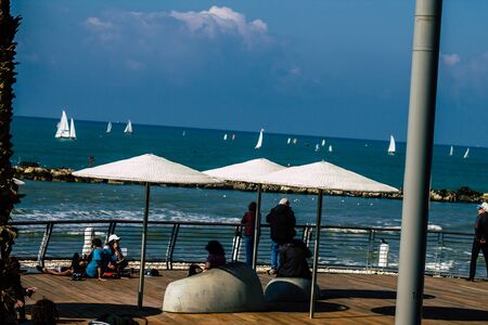 View of unidentified people walking on Herbert Samuel Promenade in Tel Aviv in the afternoonの写真素材