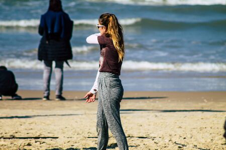 Tel Aviv Israel January 11, 2020 View of unidentified people having fun on the beach of Tel Aviv in winterの写真素材